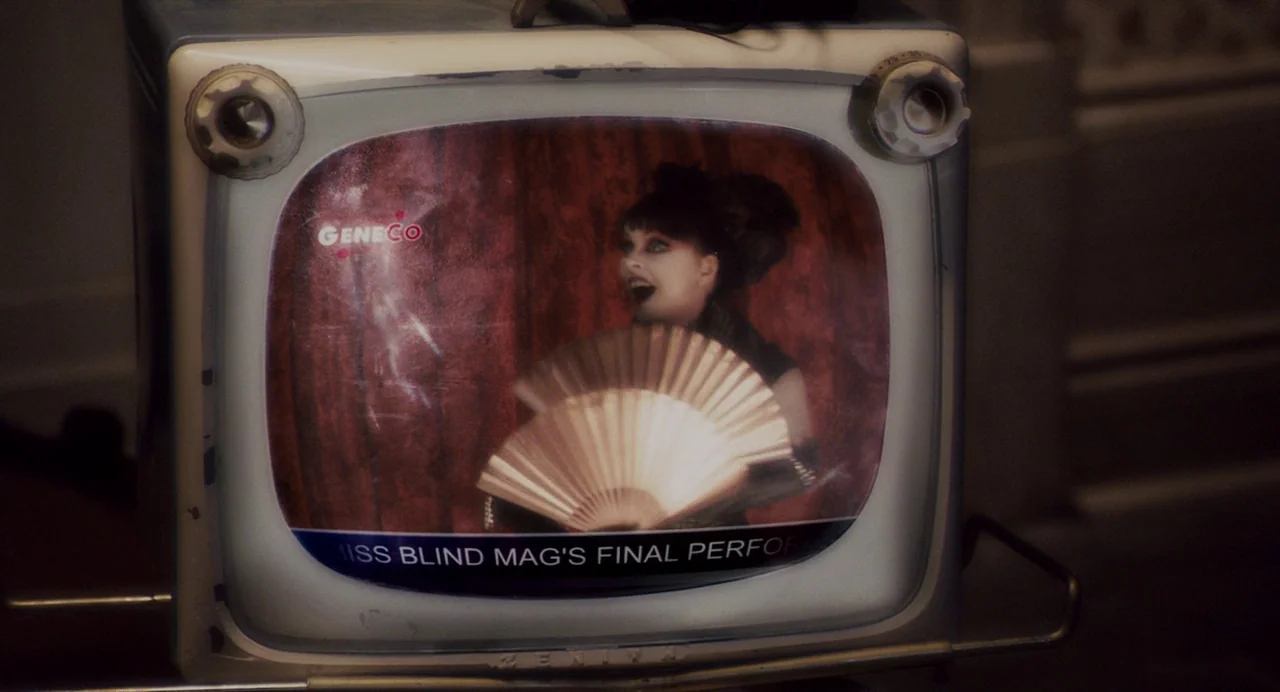 Repo! The Genetic Opera (2008) movie still: closeup — A retro-styled television set displays a digital broadcast featuring a performer in costume.…