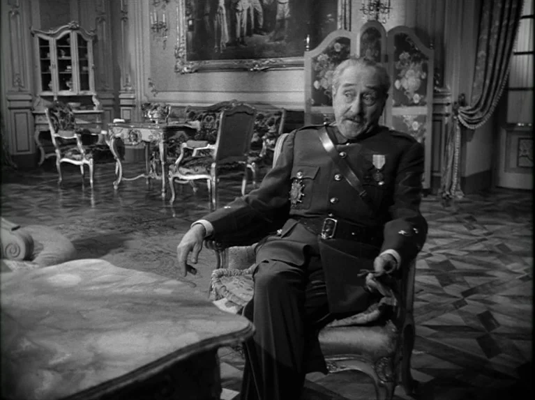 Paths of Glory (1957) movie still: medium — An opulent 1940s room features elaborate floor patterns and an antique painted screen. An older man in…