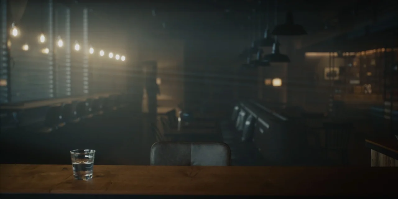 Navalny (2022) movie still: establishing — A dimly lit, hazy bar interior features rows of empty tables and hanging lights. A lone glass sits on the…