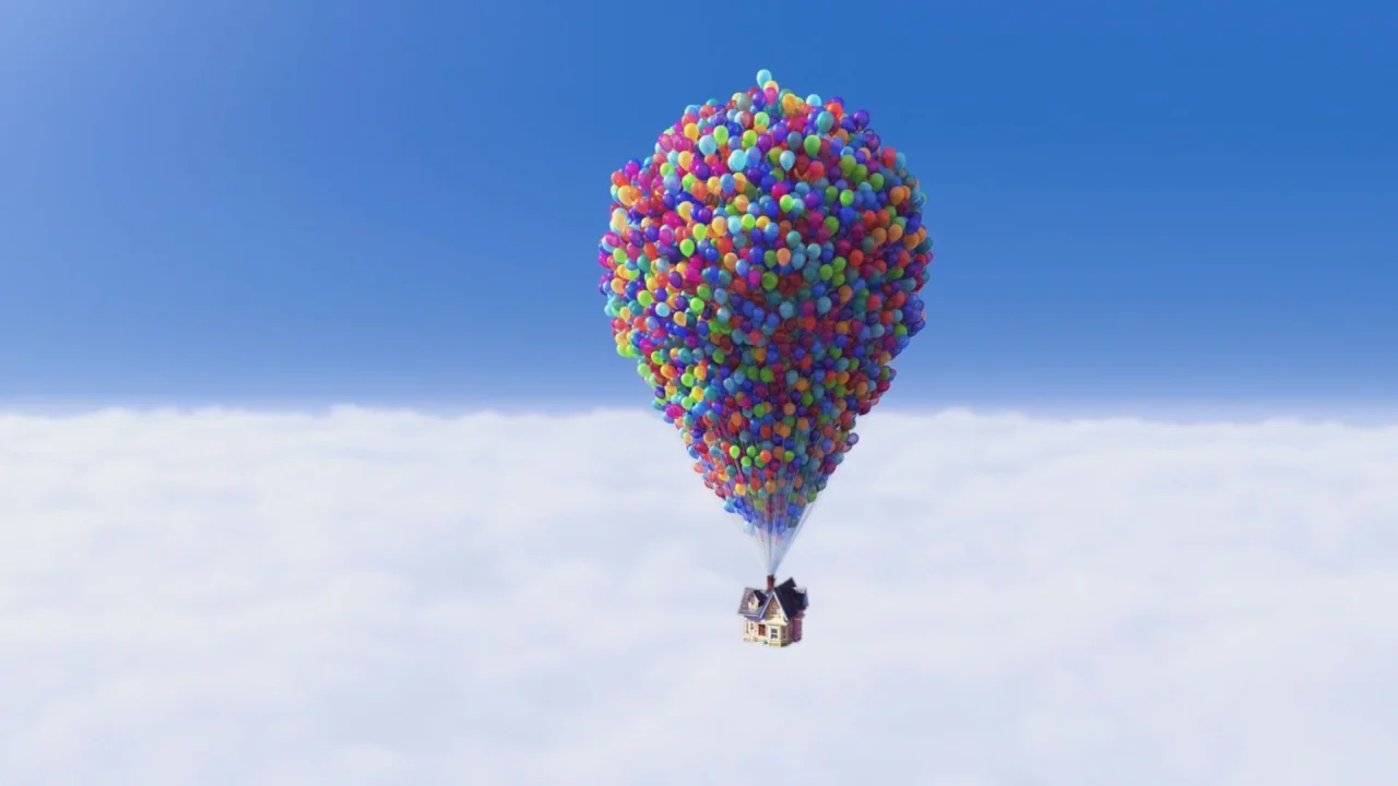 Up (2009) movie still: wide — A small suburban house is suspended in the clear blue sky by many balloons. The house floats above a thick layer of…