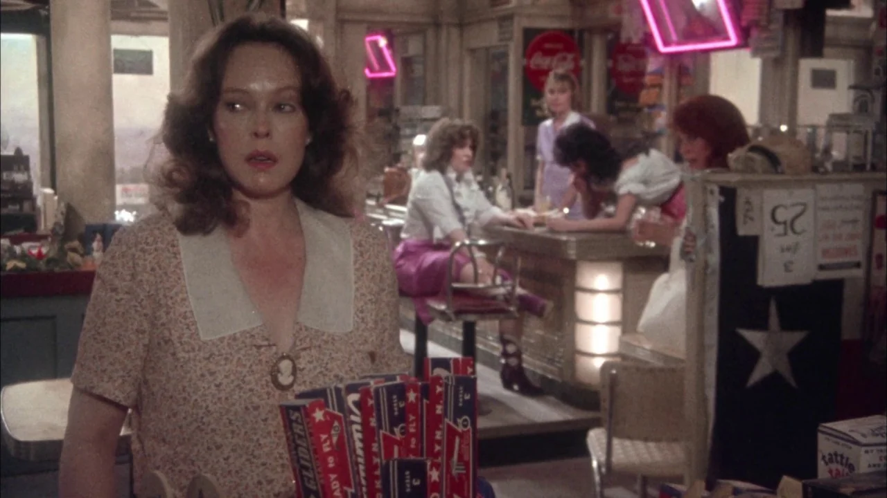 Come Back to the 5 & Dime Jimmy Dean, Jimmy Dean (1982) movie still: medium — A 1940s diner interior features counter seating, neon signage, and…