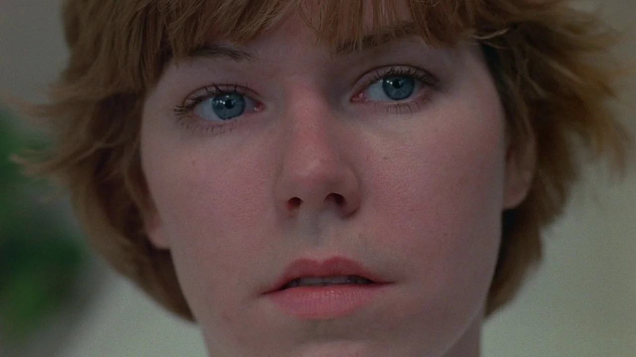 Friday the 13th (1980) movie still: closeup — A close-up view shows a woman inside an undiscernible interior setting. Her face is centered in the…