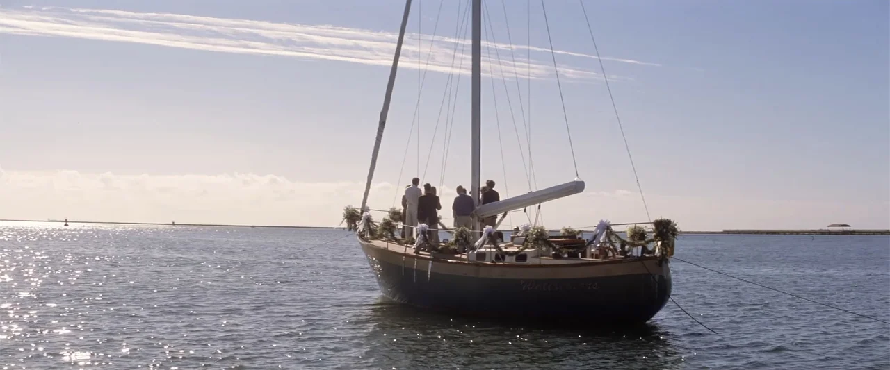 He's Just Not That Into You (2009) movie still: wide — A sailboat decorated with floral arrangements sits on the surface of calm water. A small…