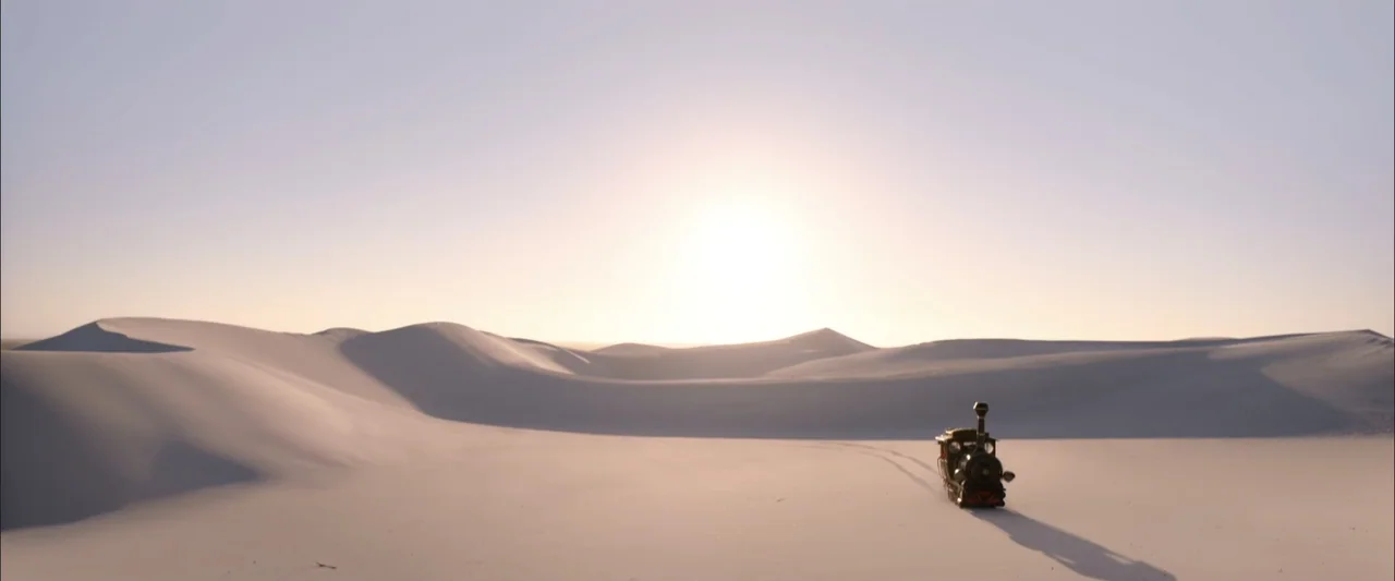 Jim Button and Luke the Engine Driver (2018) movie still: wide — Vast, rolling white sand dunes stretch toward a bright, hazy horizon under a clear…