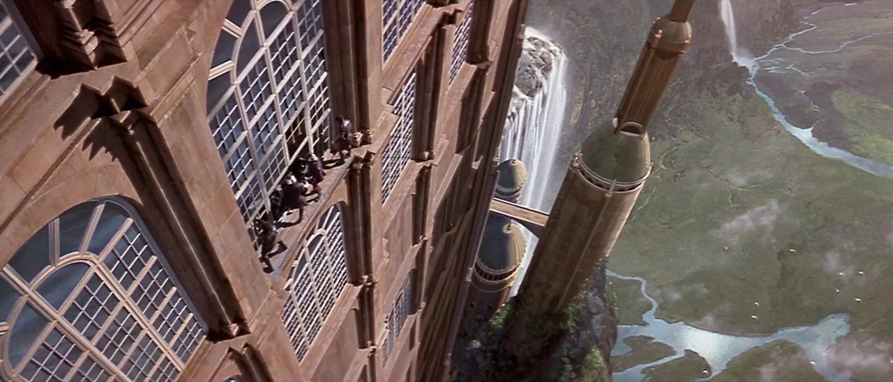 Star Wars: Episode I – The Phantom Menace (1999) movie still: wide — A monolithic stone building with large arched windows clings to a towering…