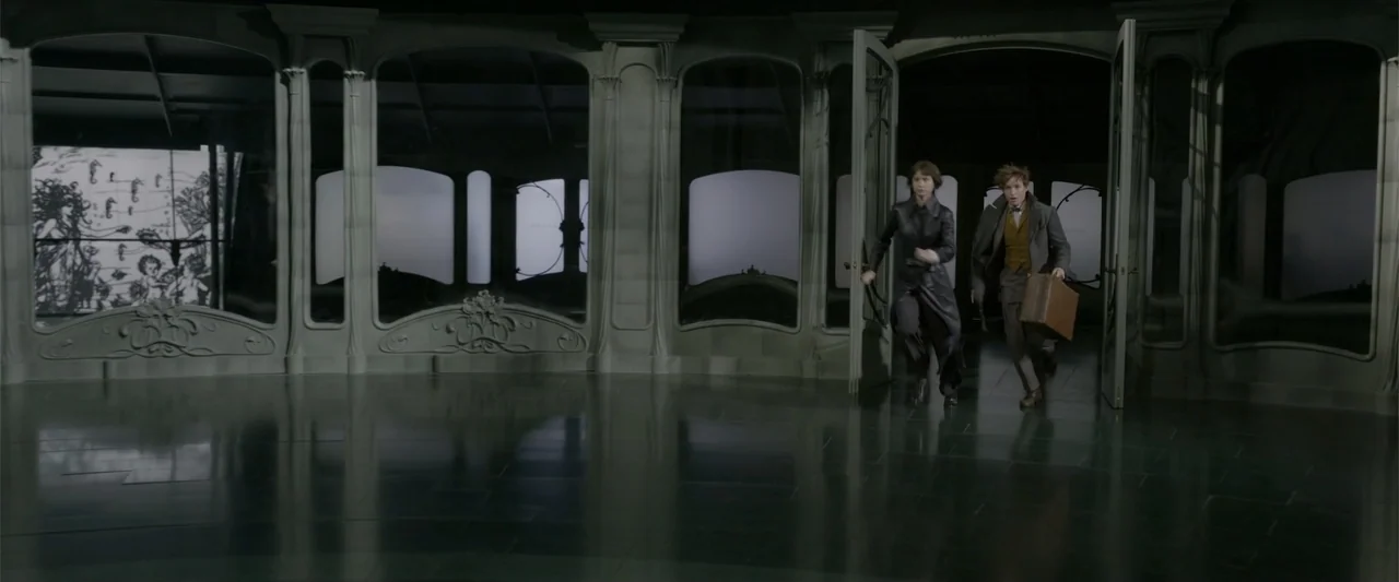 Fantastic Beasts: The Crimes of Grindelwald (2018) movie still: wide — A spacious room features high arches and dark reflective floors in a dark…
