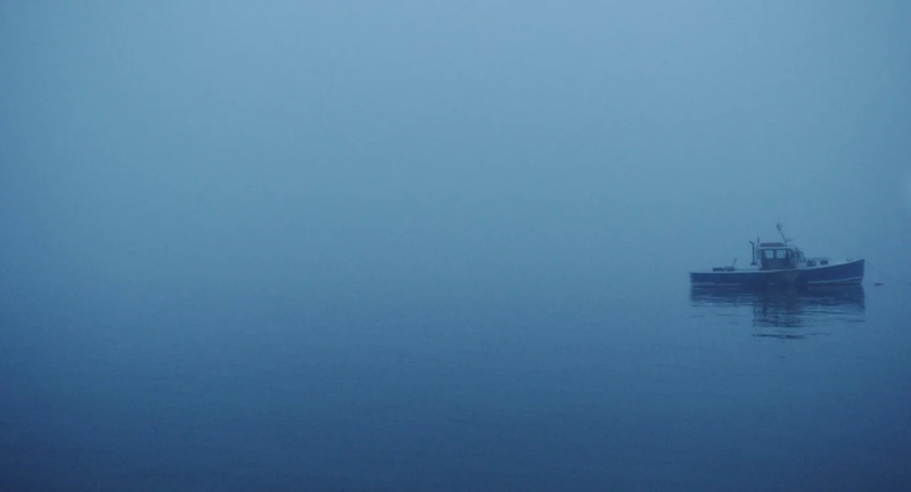 Blow The Man Down (2019) movie still: wide — A small fishing boat drifts in the center of a wide expanse of water. Thick, dense fog obscures the…