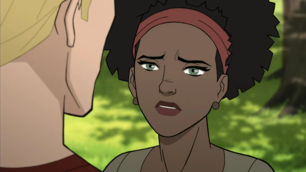 Justice Society: World War II (2021) movie still: medium — A woman with an afro stands in a park setting with green trees. She faces a man with…