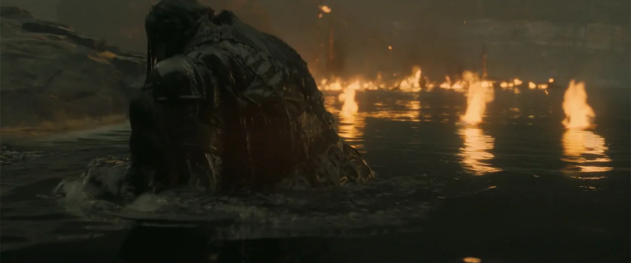 How to Train Your Dragon (2025) movie still: medium — A dark body of water is illuminated by multiple small floating fires at night. A hooded figure…