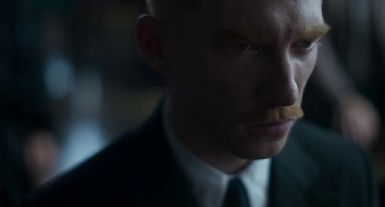 The Little Stranger (2018) movie still: closeup — An interior space features low light and minimal visible architectural detail in the background. A…
