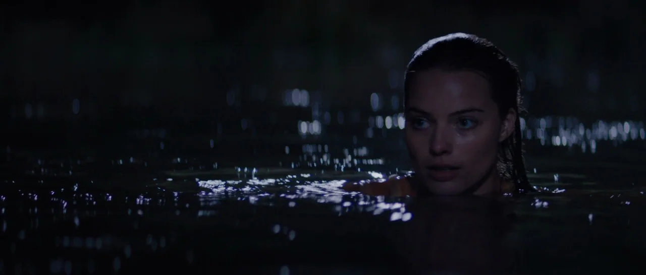 Z for Zachariah (2015) movie still: closeup — A dark body of water at night surrounds a woman's head and shoulders. The woman looks away from the…