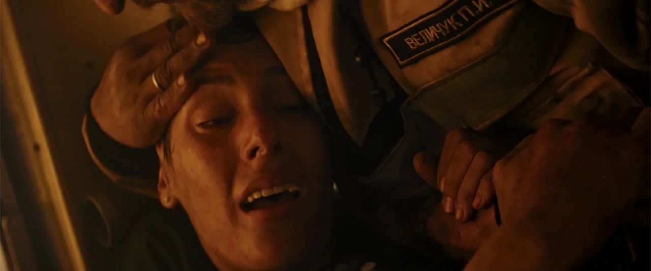 In the Line of Duty: Smoke Jumpers (1996) movie still: closeup — A dimly lit interior space with tan padded walls and visible Cyrillic text patches.…