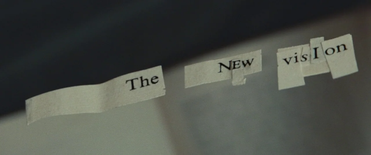 Kill Your Darlings (2013) movie still: closeup — Three strips of paper with printed text are arranged on a smooth, flat surface. The words read The,…