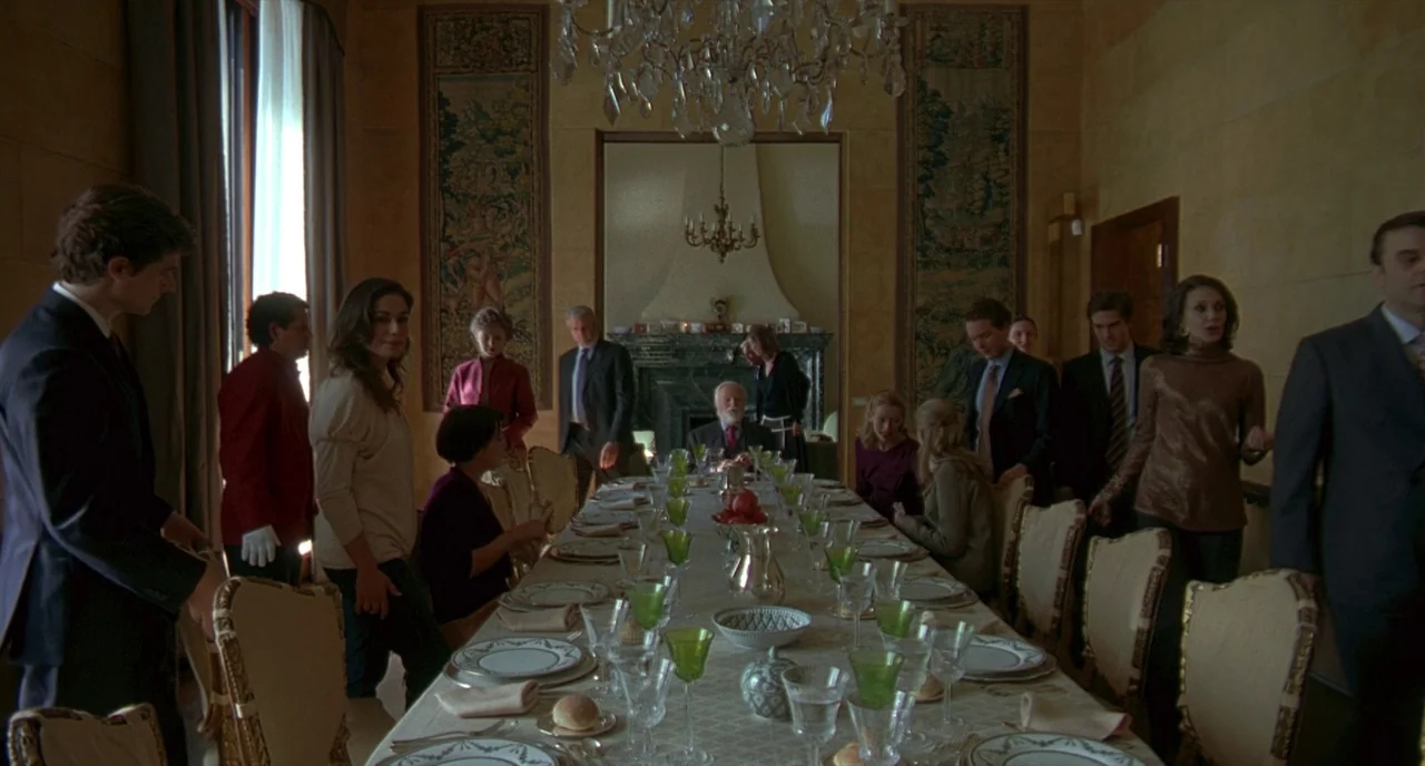 Making of: I Am Love (2009) movie still: wide — A long banquet table set for a formal meal sits in an ornate room. A large group of well-dressed…