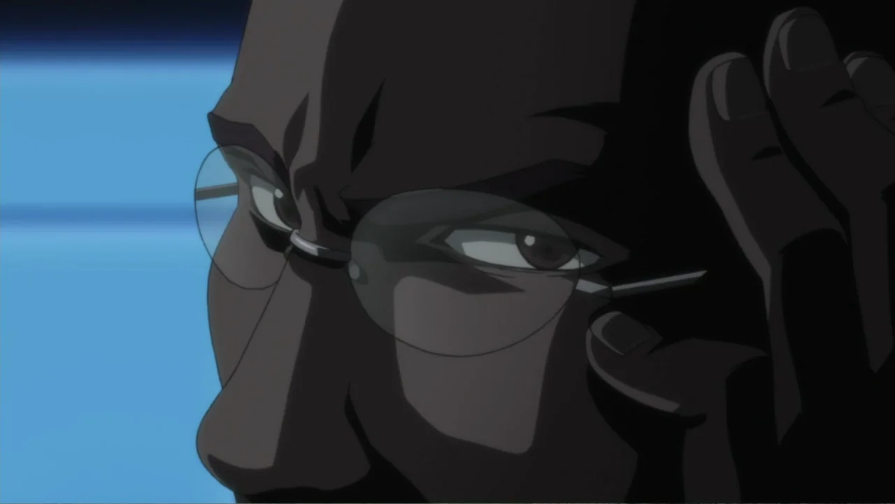 Batman: Gotham Knight (2008) movie still: closeup — An interior space with a dimly lit, blue-tinted background and dark shadows. A man with glasses…