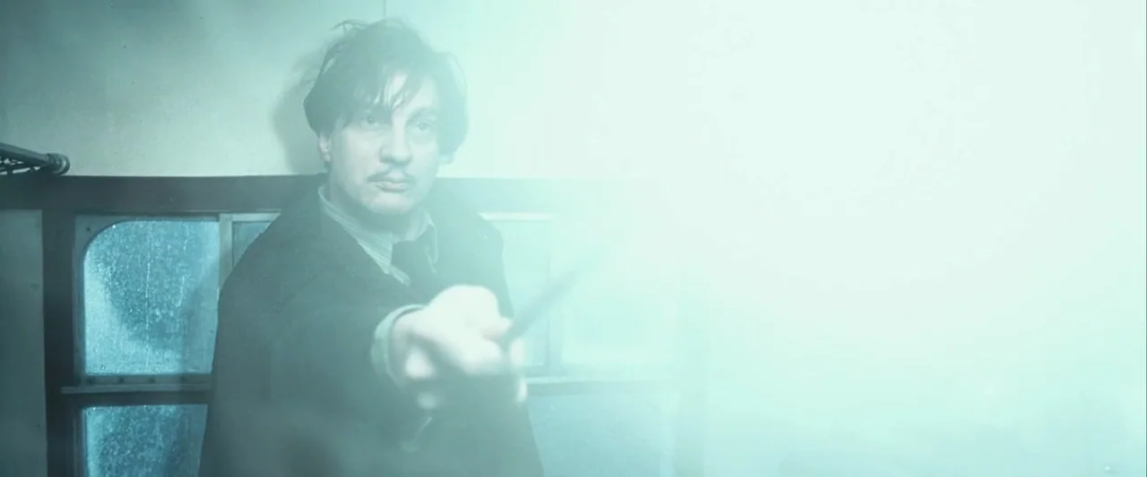 Harry Potter and the Prisoner of Azkaban (2004) movie still: medium — A dimly lit train compartment interior has a wooden-paneled back wall with a…