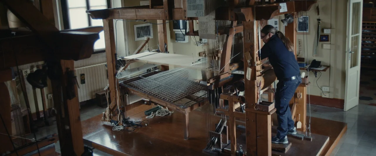 An emperor's jewel - The making of the Bulgari Hotel Roma (2024) movie still: medium — A workshop interior contains a large, traditional wooden loom…