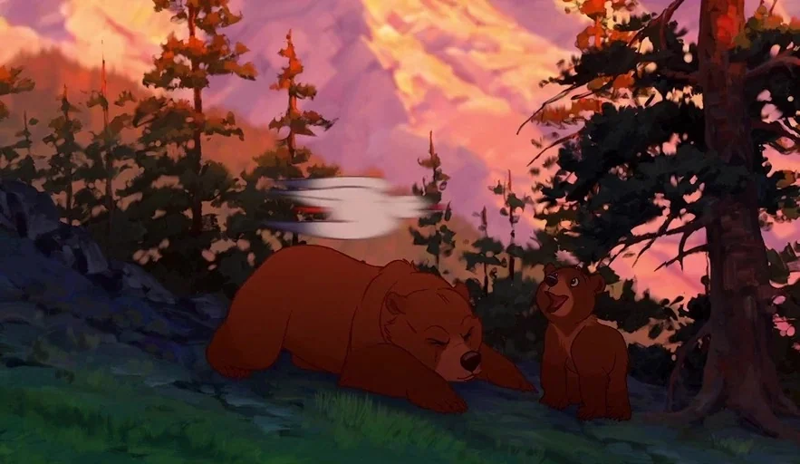 Brother Bear (2003) movie still: wide — A rugged mountain landscape during golden hour is filled with pine trees and crags. A large brown bear rests…