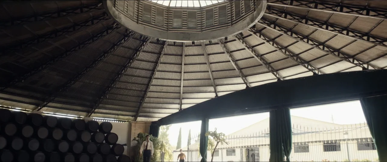 Hear Me: Our Summer (2024) movie still: wide — A circular industrial structure with a corrugated metal roof and central circular skylight.
