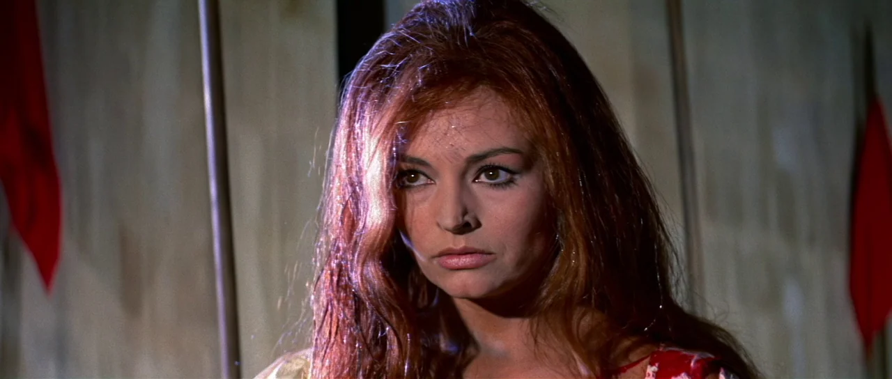 Night of the Blood Monster (1970) movie still: closeup — An interior space draped with light colored fabric. A woman with long reddish hair looks…