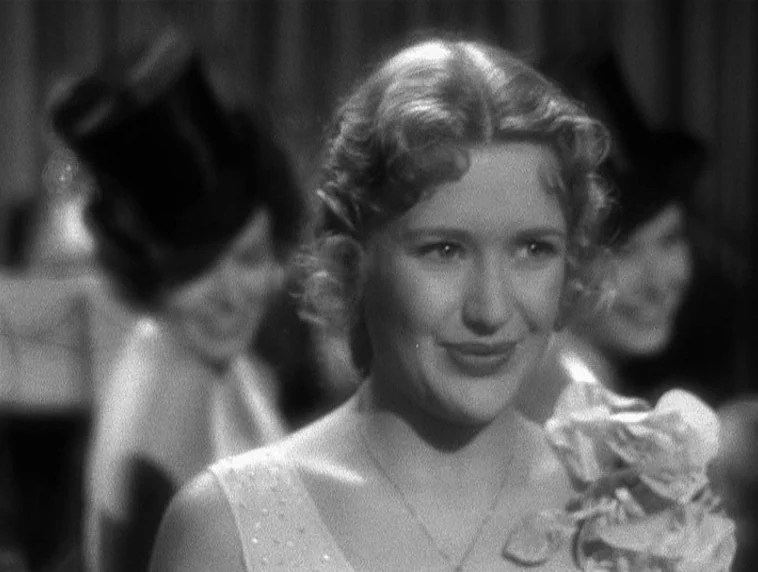 The Roaring Twenties (1939) movie still: closeup — A crowded social gathering with individuals wearing hats in the blurred background. A young woman…