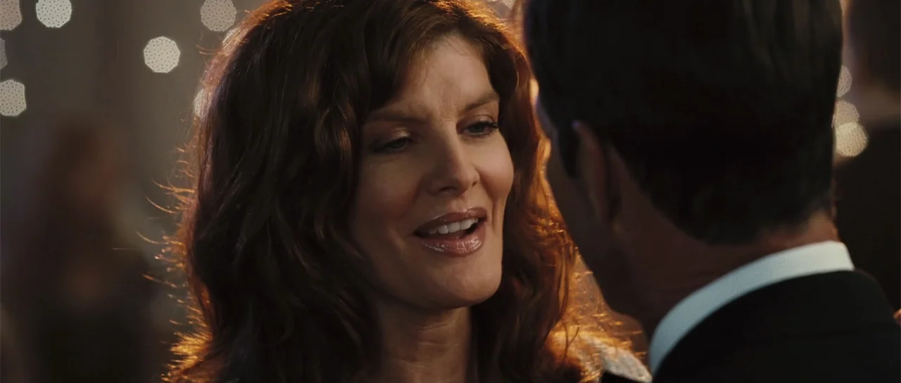 Yours, Mine & Ours (2005) movie still: closeup — An interior space with warm bokeh lights in the background indicating a social event. A woman faces…