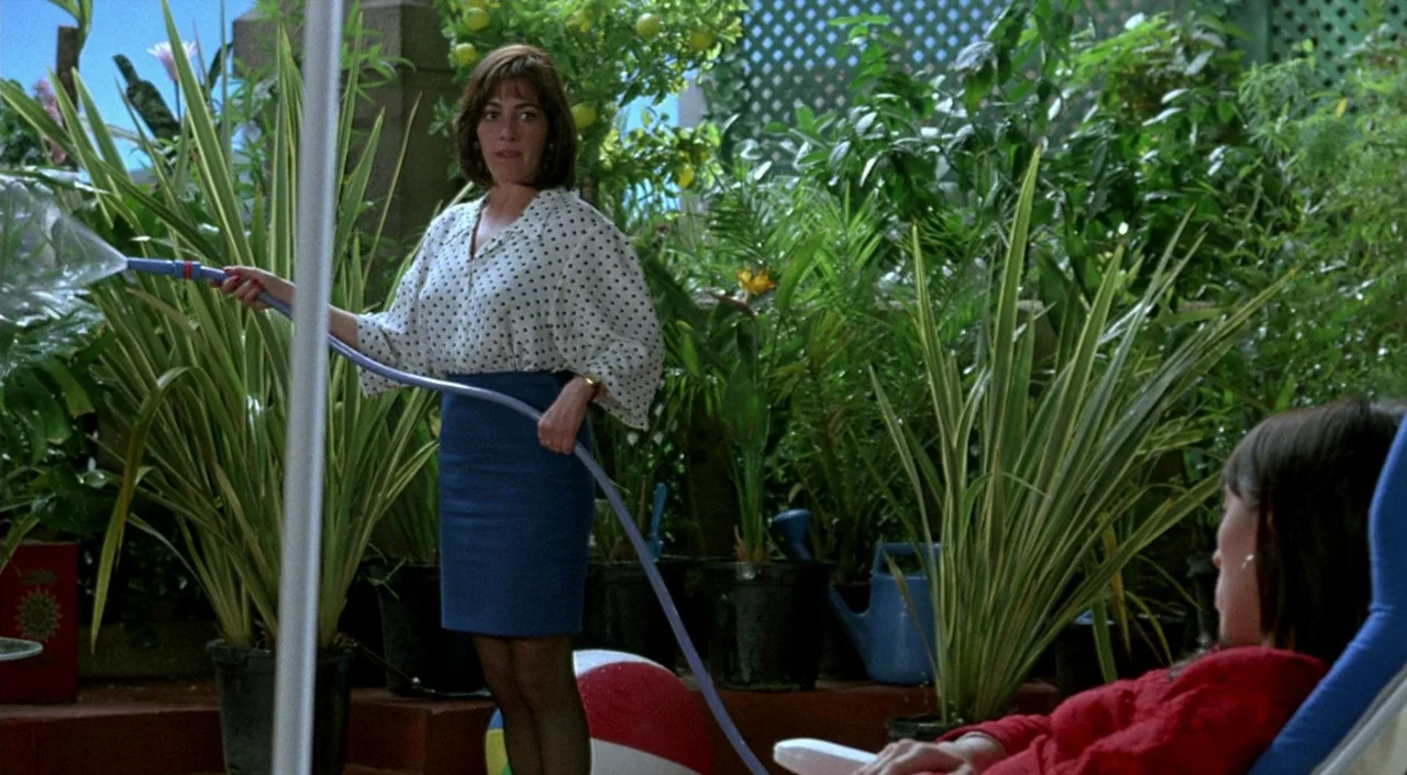Women on the Verge of a Nervous Breakdown (1988) movie still: medium — A patio filled with numerous potted plants and small trees in a residential…