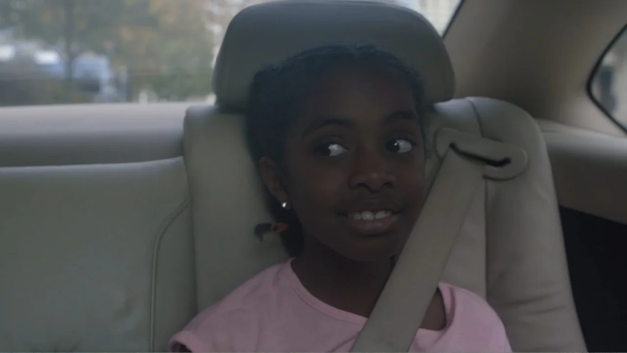 A Film Called Blacks Can't Swim (My Journey My Story) (2020) movie still: closeup — The interior of a vehicle backseat with beige leather upholstery…