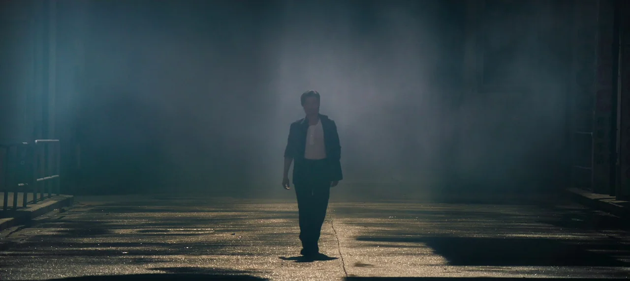 Master Z: The Ip Man Legacy (2018) movie still: fullbody — A man walks alone down a dark asphalt street filled with thick, low-lying fog. The…