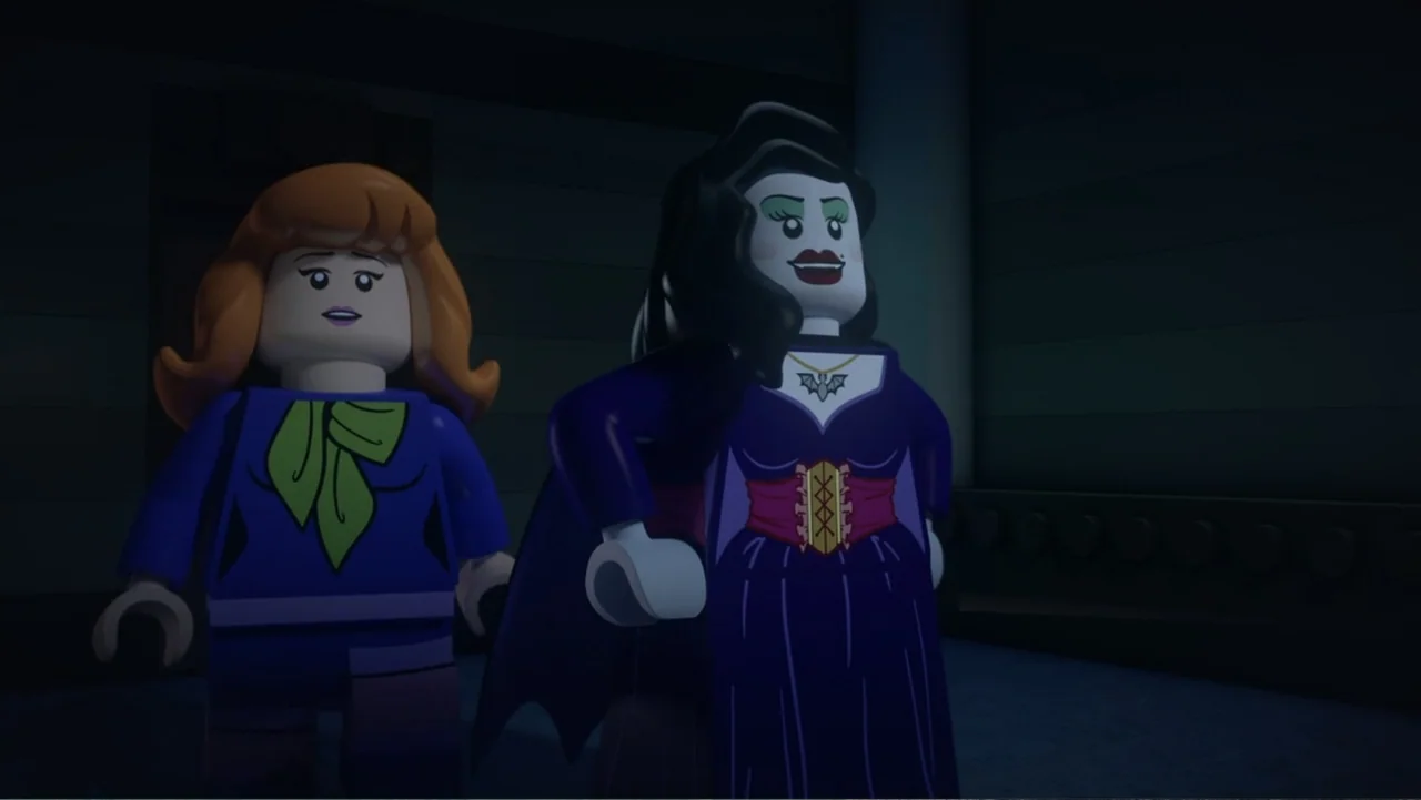 LEGO Scooby-Doo! Haunted Hollywood (2016) movie still: medium — Two lego minifigures stand in a dark, empty indoor space. The characters face the…