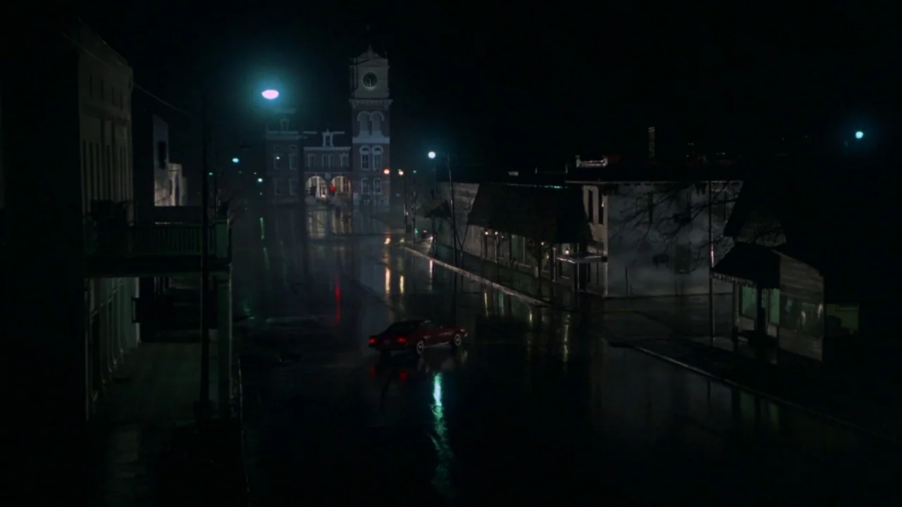 Friday the 13th Part VI: Jason Lives (1986) movie still: wide — A deserted town square features a central courthouse clock tower and dark…