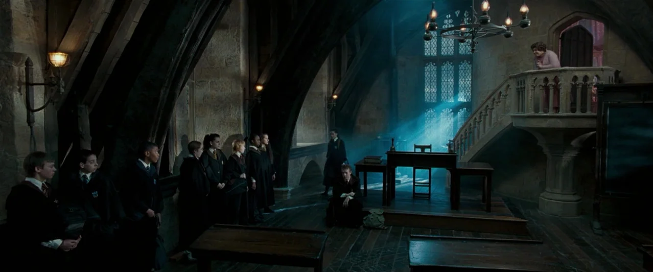 Harry Potter & The Order of the Phoenix (2007) movie still: wide — A dark stone classroom with high vaulted ceilings and pointed stone archways. A…