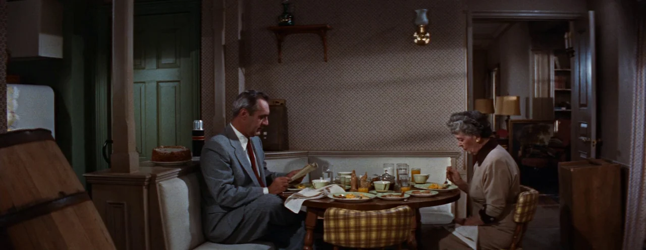 Rebel Without A Cause (1955) movie still: wide — A small mid-century dining nook features wallpaper with a small geometric pattern. A man and a…