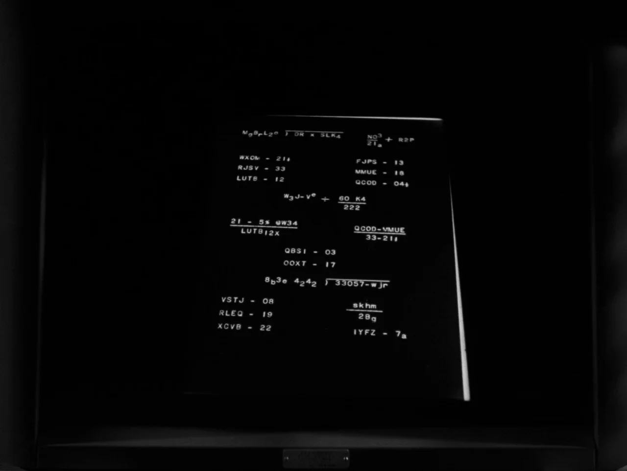 Pickup on South Street (1953) movie still: closeup — A dark, enclosed space features a central display screen showing complex mathematical-looking…