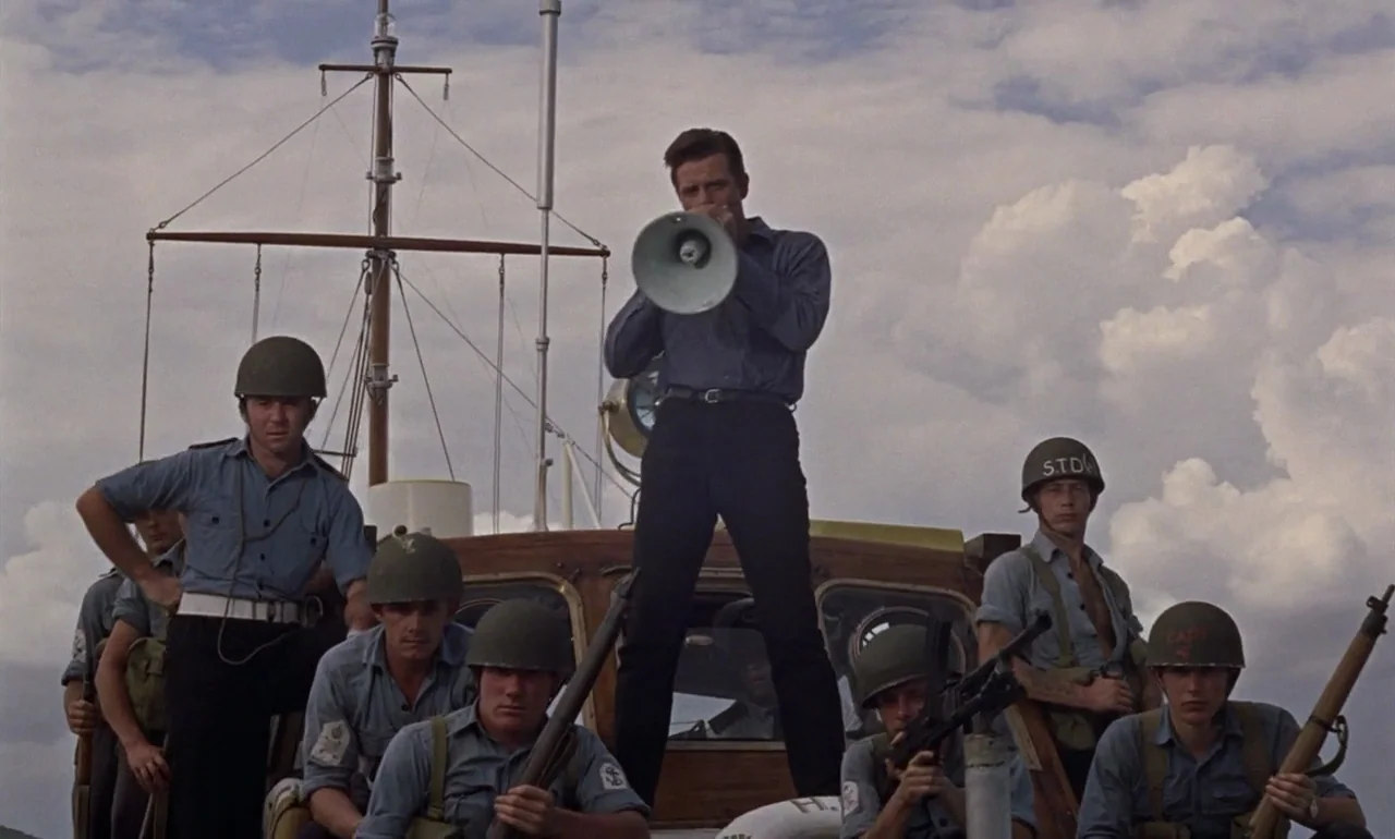 Dr. No (1962) movie still: fullbody — A wooden military boat deck features a group of soldiers wearing helmets and uniforms. A central figure stands…
