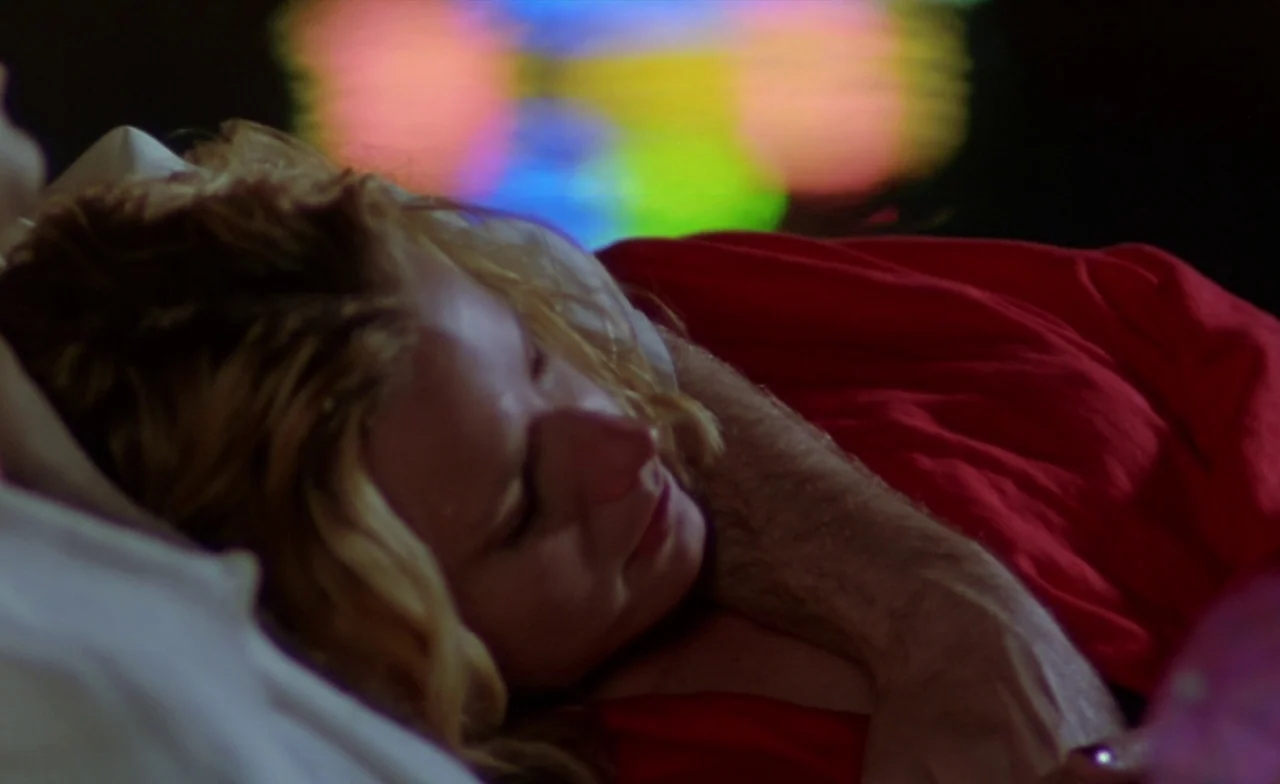 Leaving Las Vegas (1995) movie still: closeup — A woman lies with her head resting on a man's chest. They are positioned closely together on a bed…