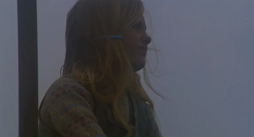 The Secret Of Roan Inish (1994) movie still: medium — A young girl with blonde hair stands in a misty outdoor setting. The girl looks to the right…