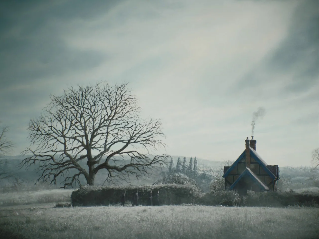 The Electrical Life of Louis Wain (2021) movie still: establishing — A rural landscape features a bare, gnarled tree standing beside a small stone…