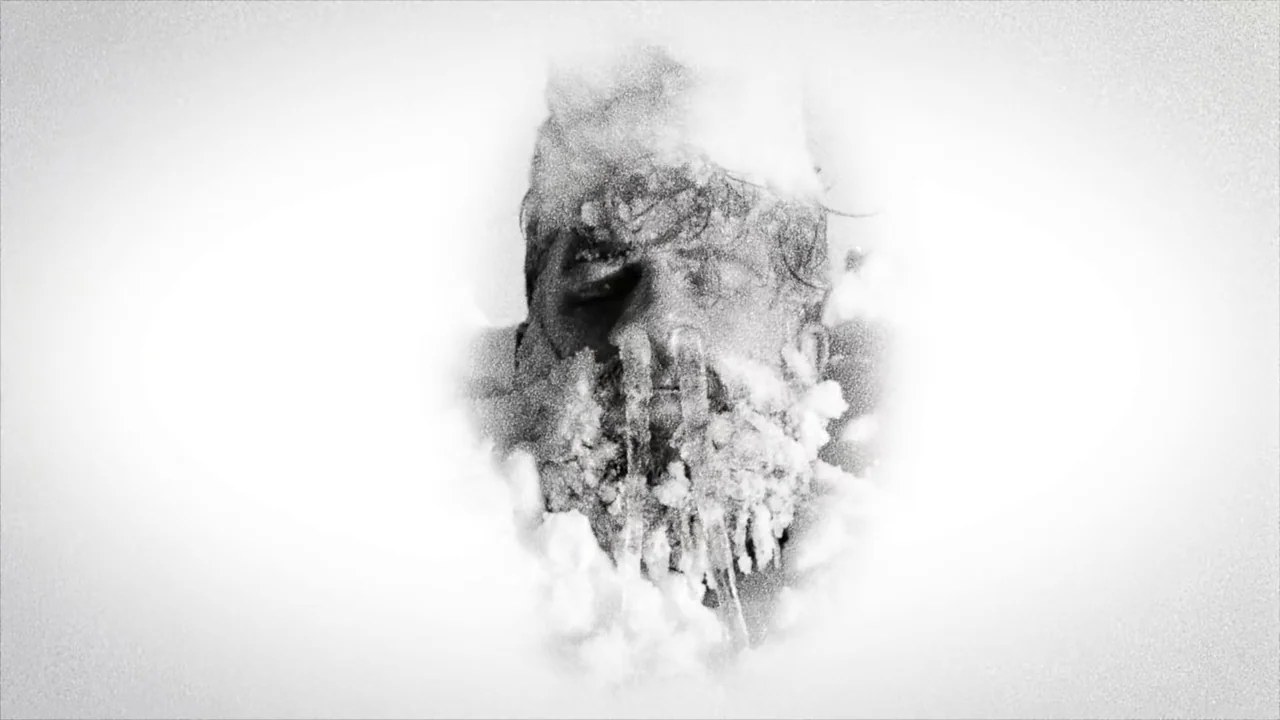 Hundreds of Beavers (2022) movie still: closeup — A man's face is partially encased in frozen ice and heavy snow. The subject lies still with his…