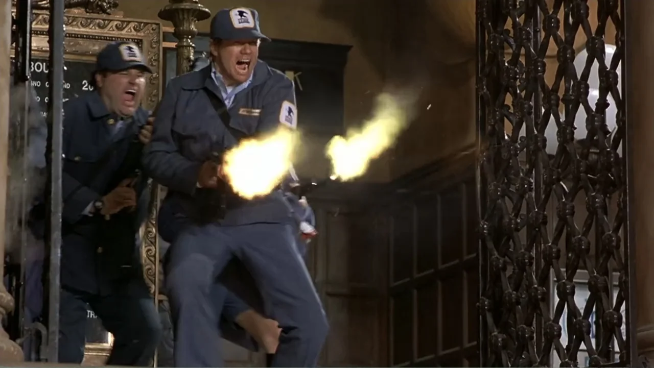 Naked Gun 33⅓: The Final Insult (1994) movie still: fullbody — An indoor building lobby features dark woodwork and an ornate metal security gate.…