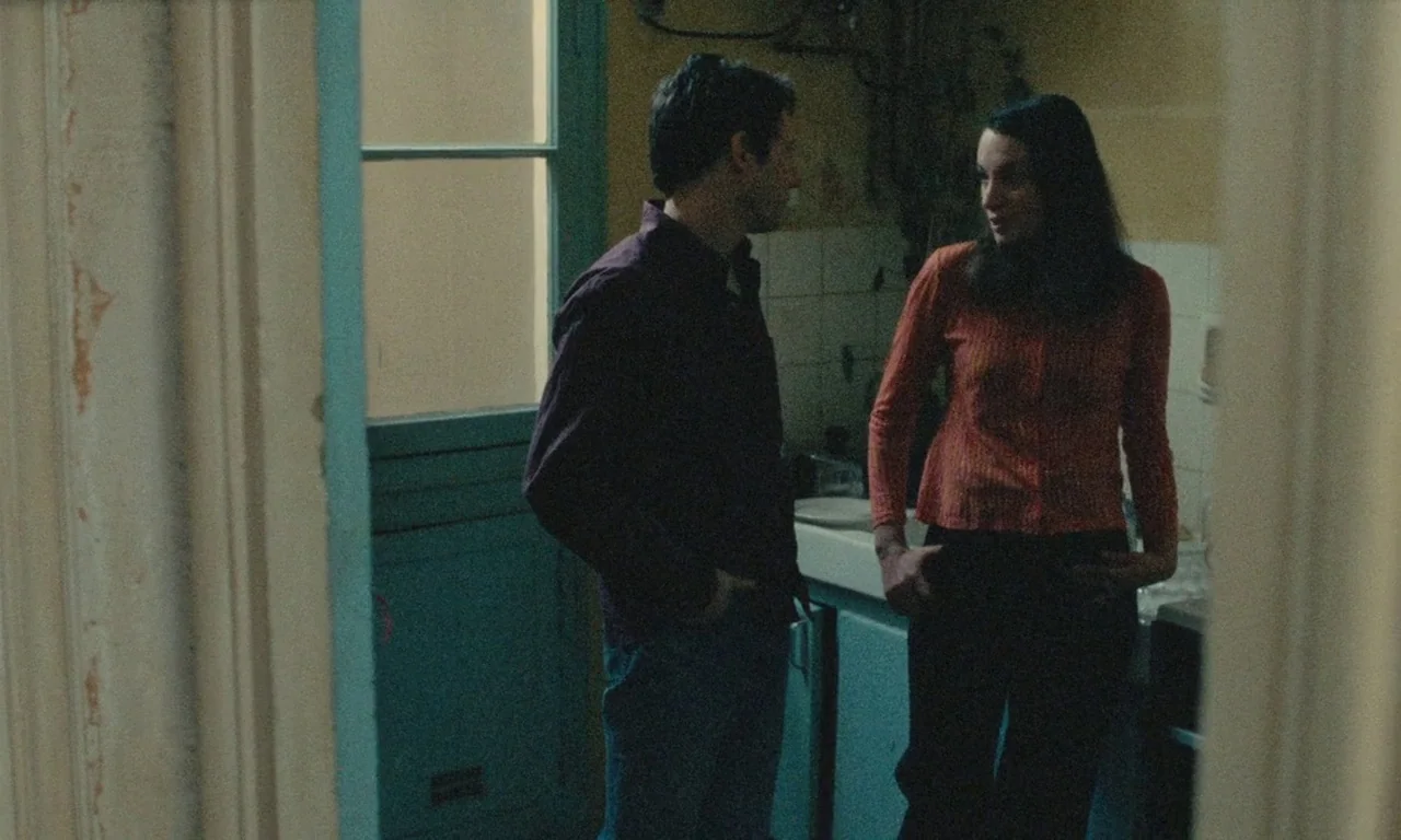 Late August, Early September (1998) movie still: medium — A residential room featuring tiled surfaces and a doorway leading to a brighter area. A…