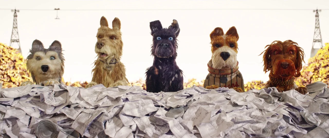 Isle of Dogs (2018) movie still: medium — Five distinct canine figures line up behind a vast mound of scattered white paper. Metal electrical towers…