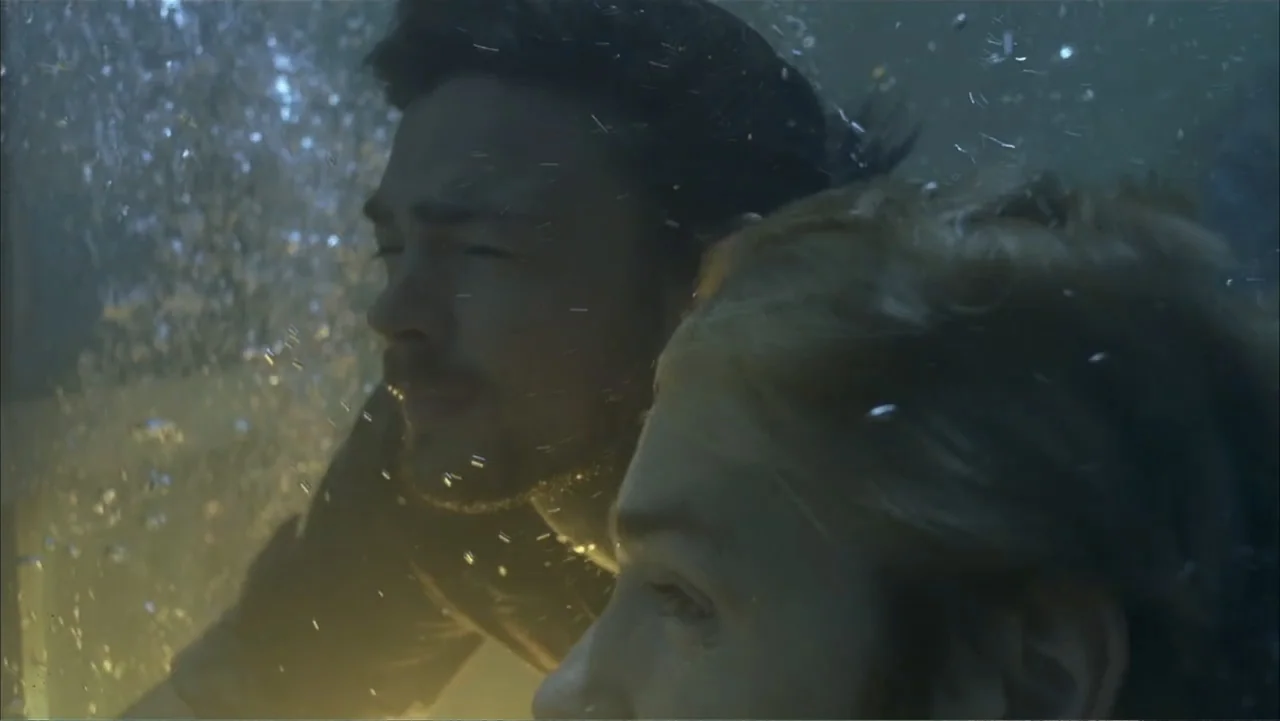 Ghost Ship (2002) movie still: closeup — An underwater view shows two people submerged with bubbles circulating around their faces. The man and…