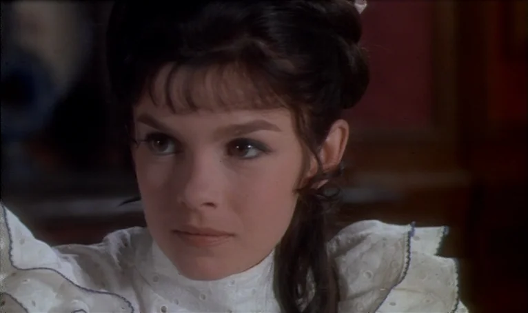 The Thief of Paris (1967) movie still: closeup — A dimly lit indoor space with blurred background decor hinting at period furniture. A young woman…