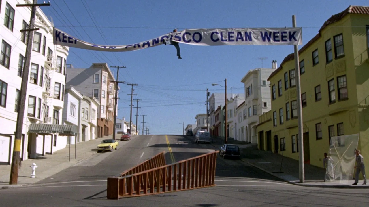 What’s Up, Doc? (1972) movie still: wide — A quiet San Francisco street slopes upward with multi-colored apartment buildings lining both sides. A…