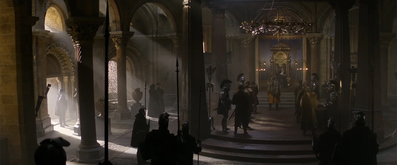 King Arthur: Legend of the Sword (2017) movie still: wide — A dark stone hall with vaulted ceilings and large ornate stone columns.