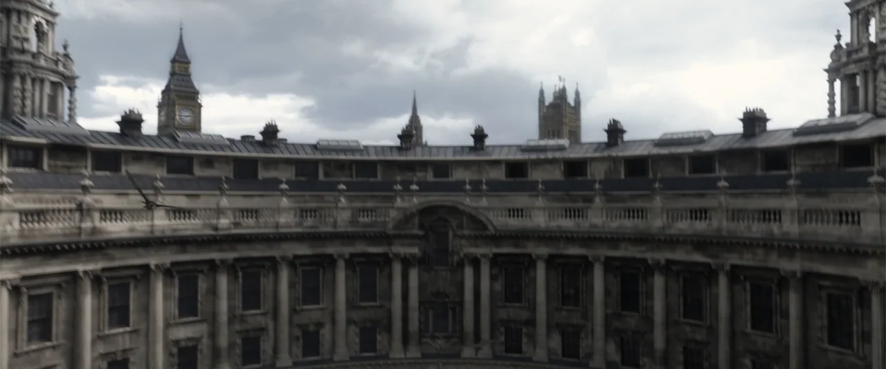 Fantastic Beasts: The Crimes of Grindelwald (2018) movie still: establishing — A circular courtyard features neoclassical stone columns and dark…
