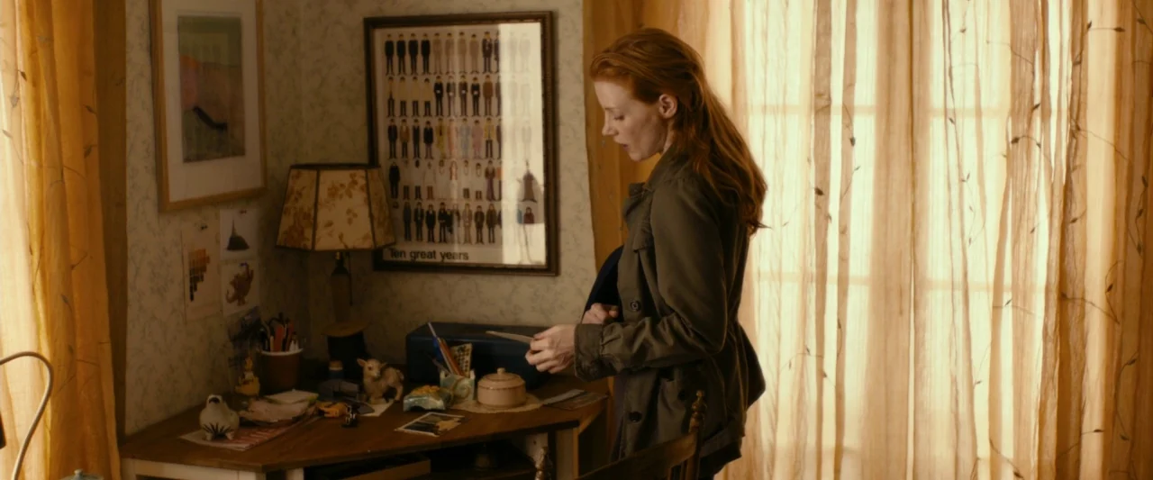 The Disappearance of Eleanor Rigby: Her (2014) movie still: medium — A study contains a wooden desk cluttered with small personal items and framed…