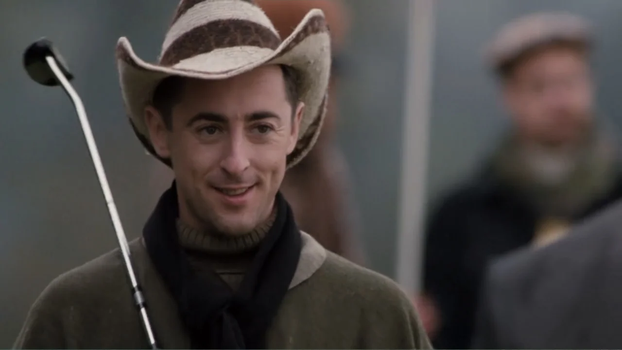 Get Carter (2000) movie still: medium — An outdoor golf course features a man dressed in historical attire. The subject stands in the foreground,…