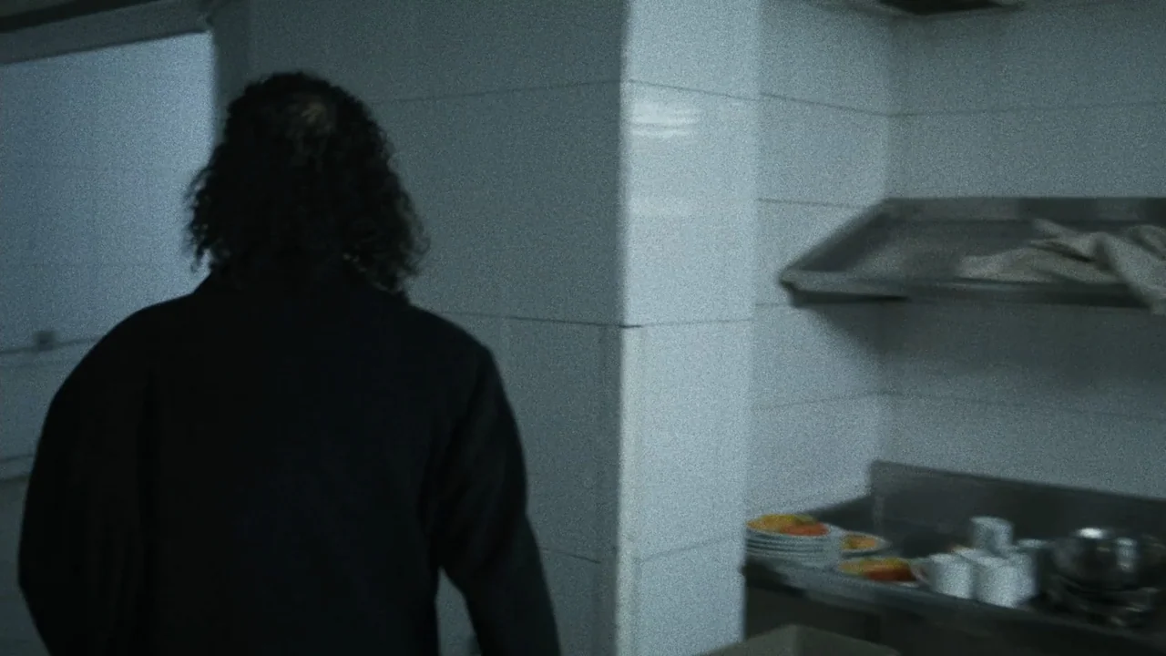 An Affair: A Dangerous Sexual Play (2014) movie still: medium — A dark, tiled commercial kitchen features a stainless steel shelf and counter space.…